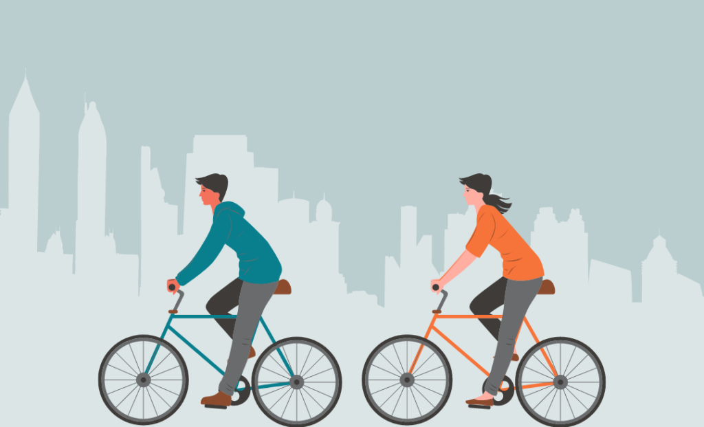 Zwei Personen fahren Fahrrad vor einer Skyline